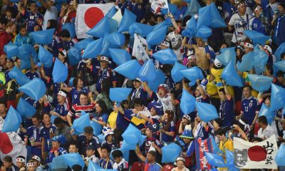 Japan fans clean the stadium